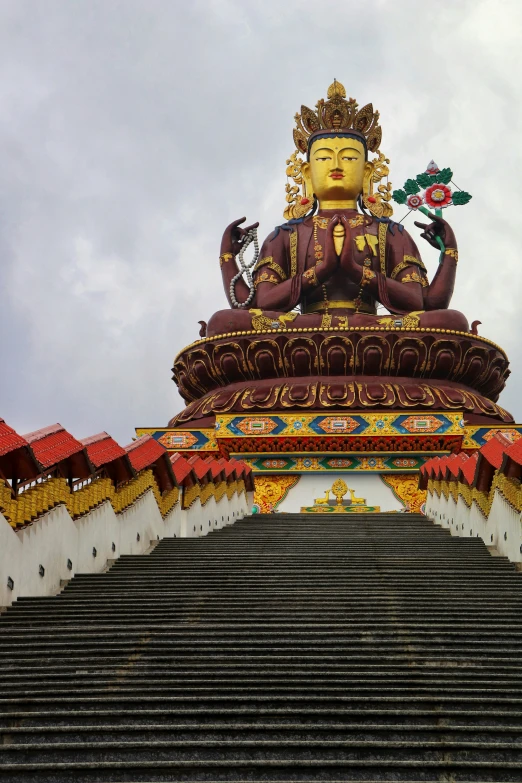 the statue of buddha sits at the top of some steps