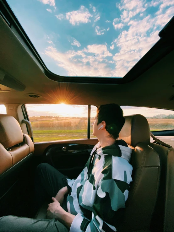 a person sitting in the back seat of a vehicle