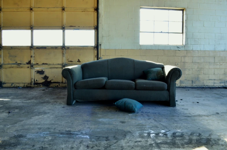 an odd looking chair on the floor in front of two windows