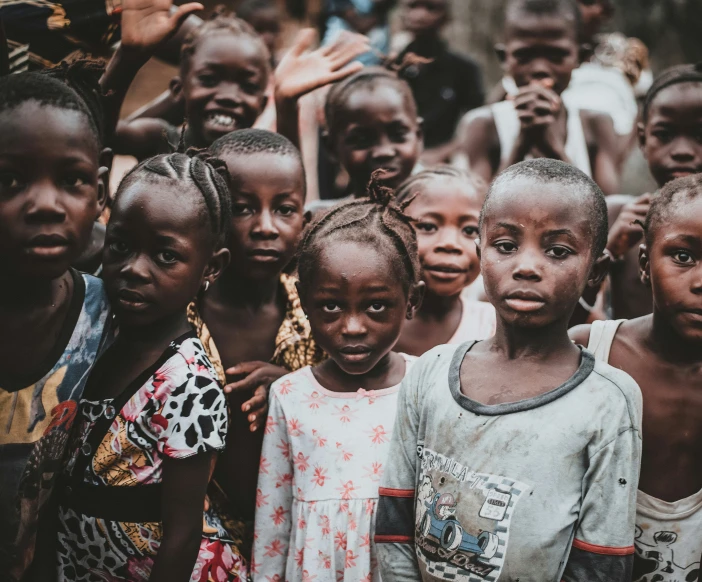 group of young children, each with dark skin and brown eyes