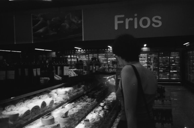 a woman looking at goods for sale in a store