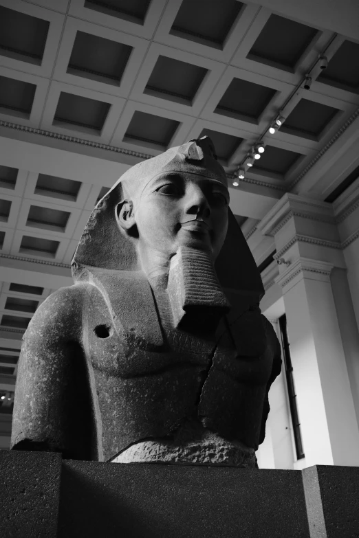 a black and white pograph of a egyptian statue