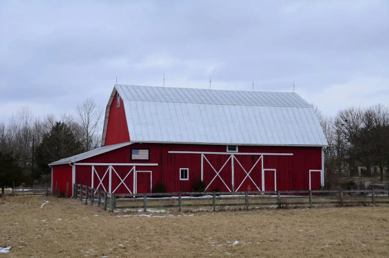 a barn in the country with a big red roof