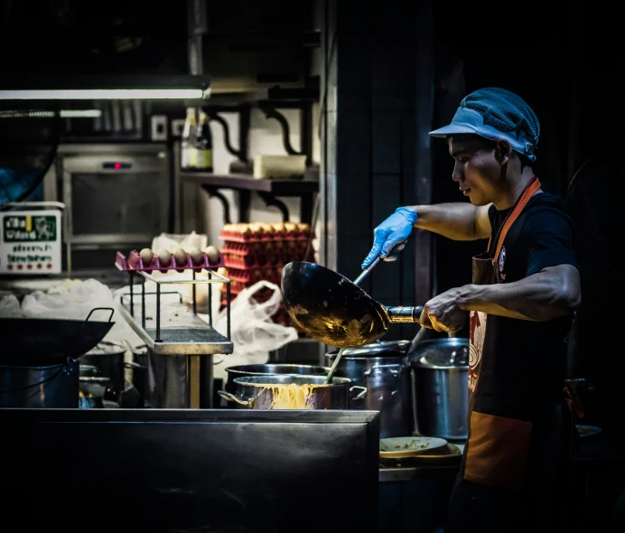 a cook cooking food in a set on a stove