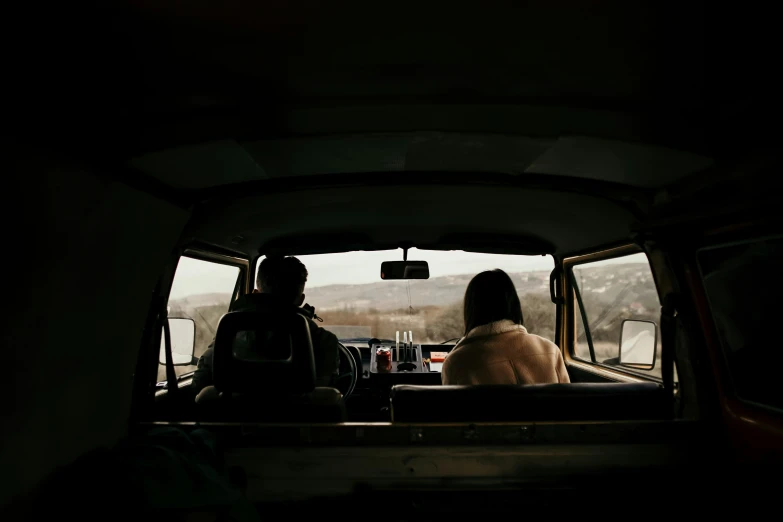 the back of a truck with two people in it