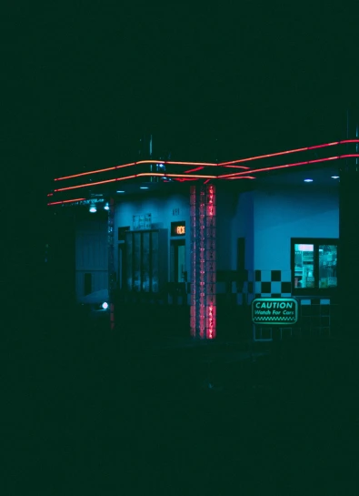 a motel with neon lights on the building
