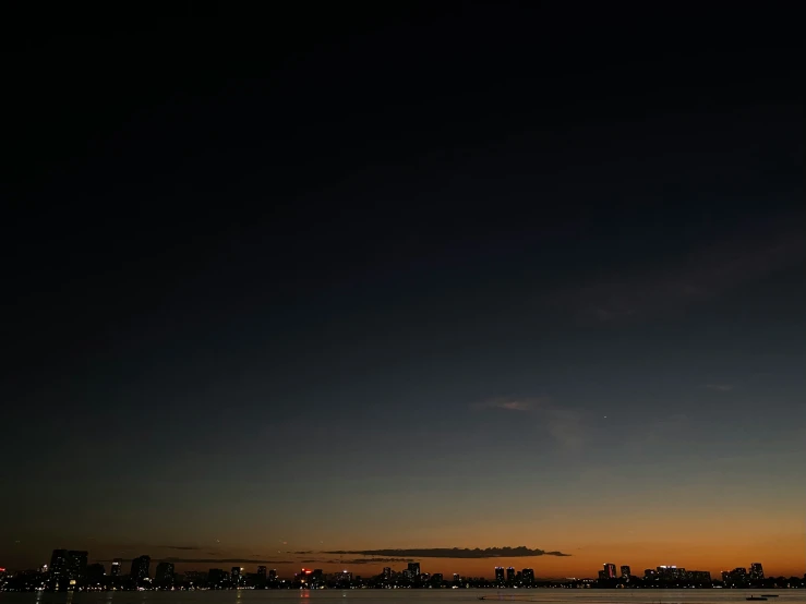 the skyline is silhouetted against the dark background