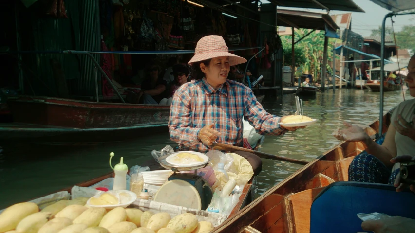 a man wearing a pink hat and holding a plate in his hand