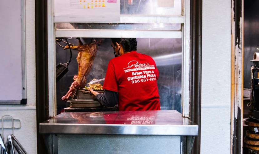 a person preparing food inside of a kitchen