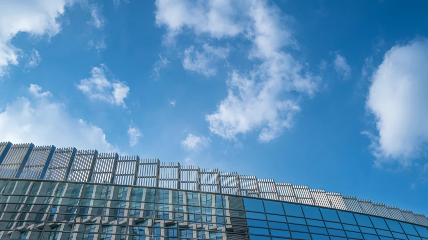 clear blue sky reflected in a window with a metal lattice design