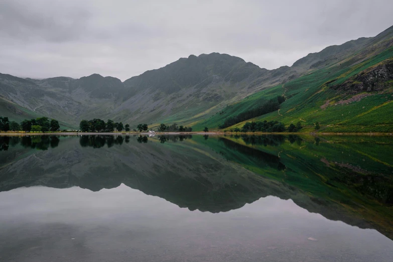 a small lake in the middle of some mountains