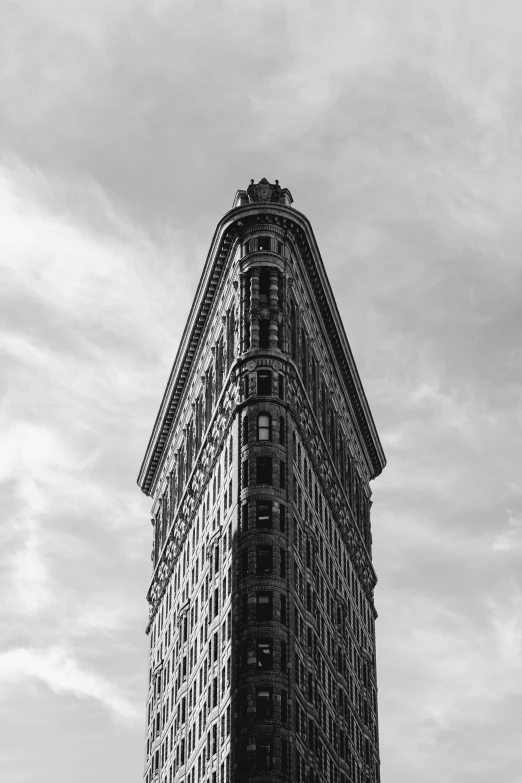 a tall building with a clock and a sky background