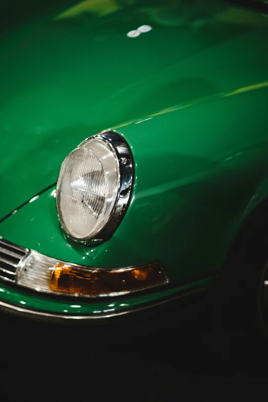 a bright green old car with some headlights on it