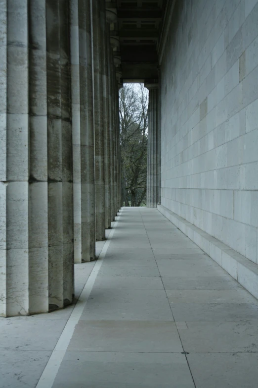 the side of an old building with columns in the foreground