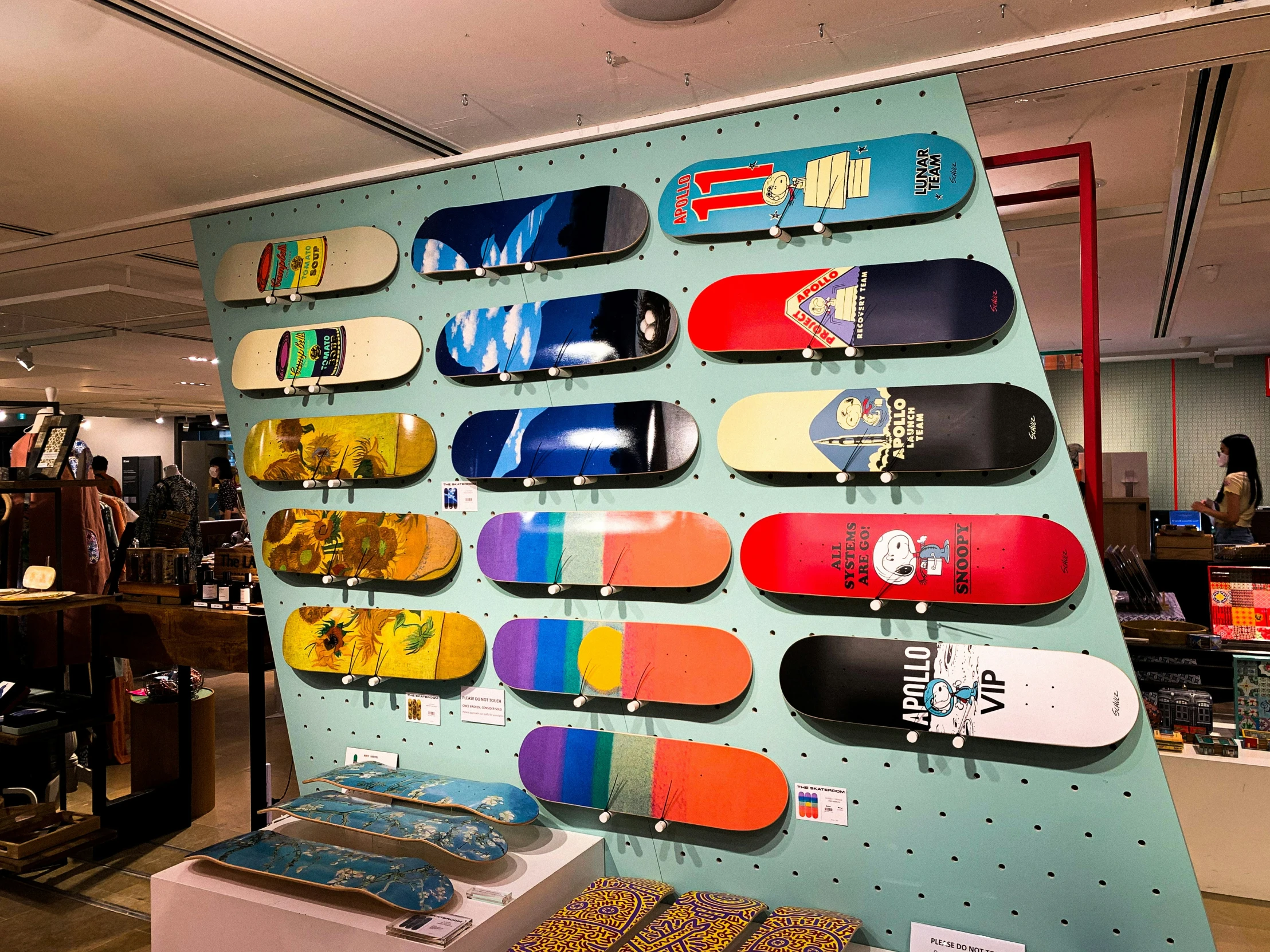 multiple skateboards are on display on display walls