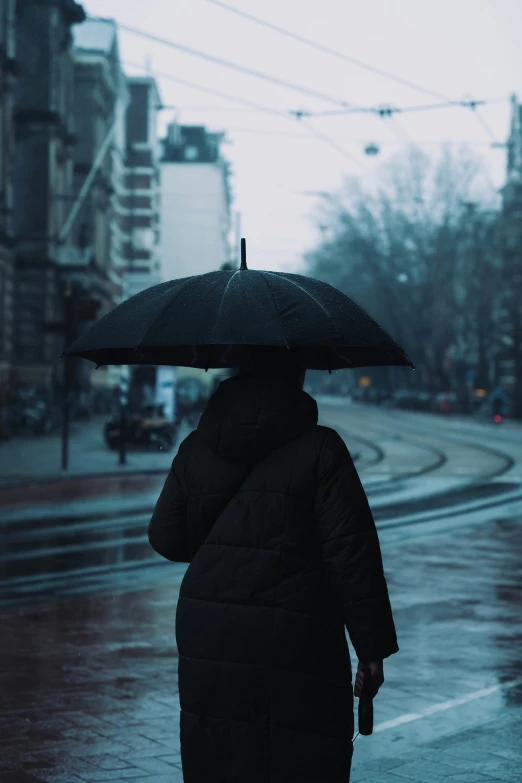 a person walking down the road with an umbrella