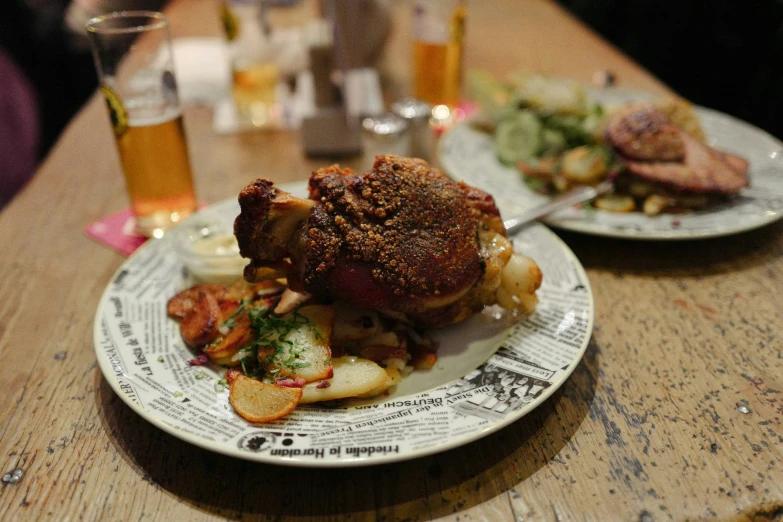 a piece of meat on top of a pile of potatoes on a plate