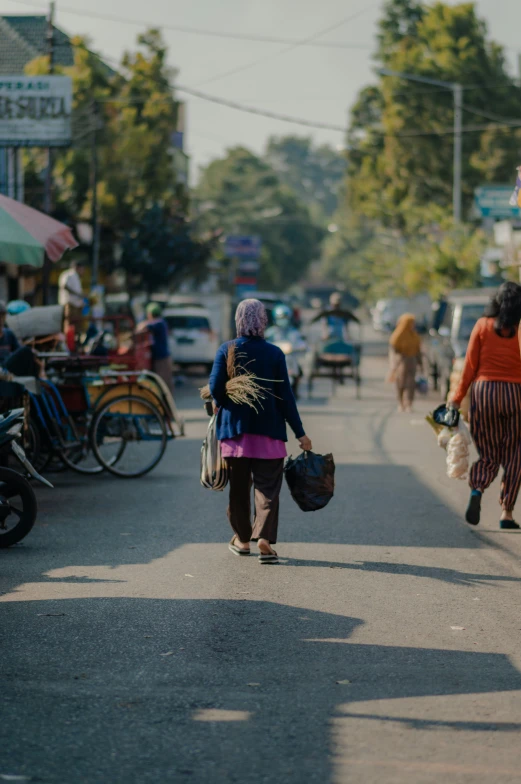 people walking down a street near the sidewalk