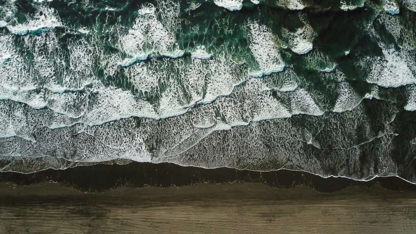 the top view of a beach with water