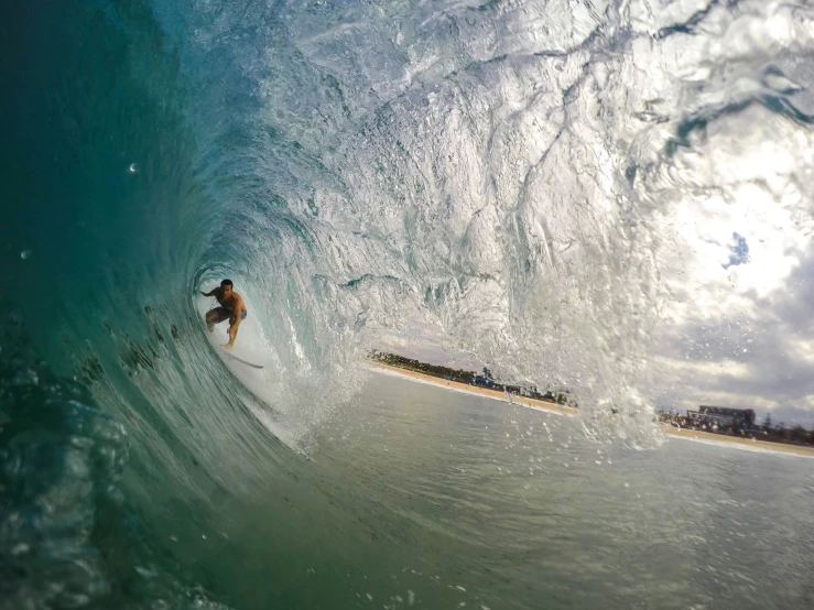 a man riding a wave on top of a surfboard