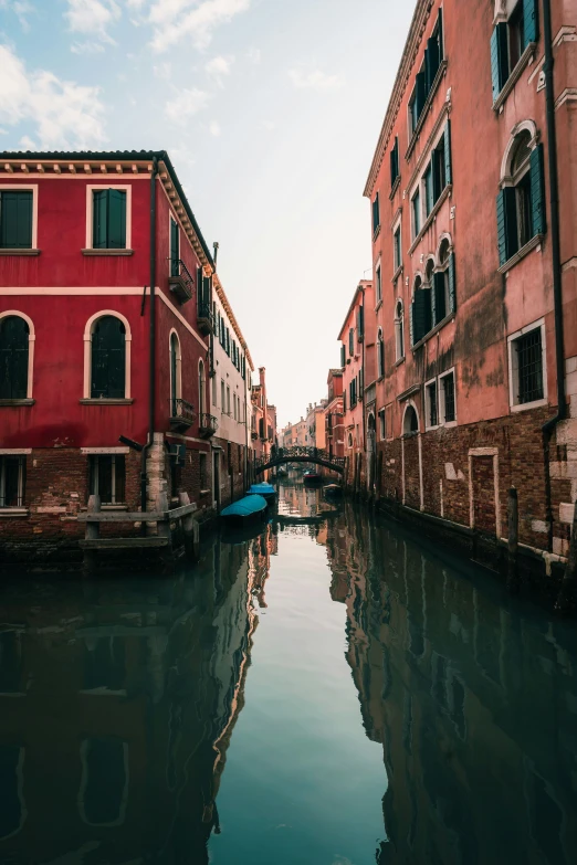 the boats are tied to the old buildings along the river