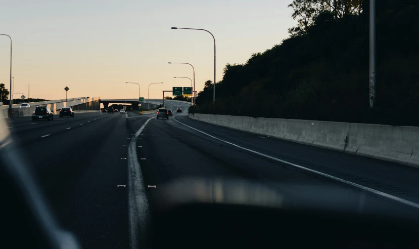 an image of a sunset view from inside a car