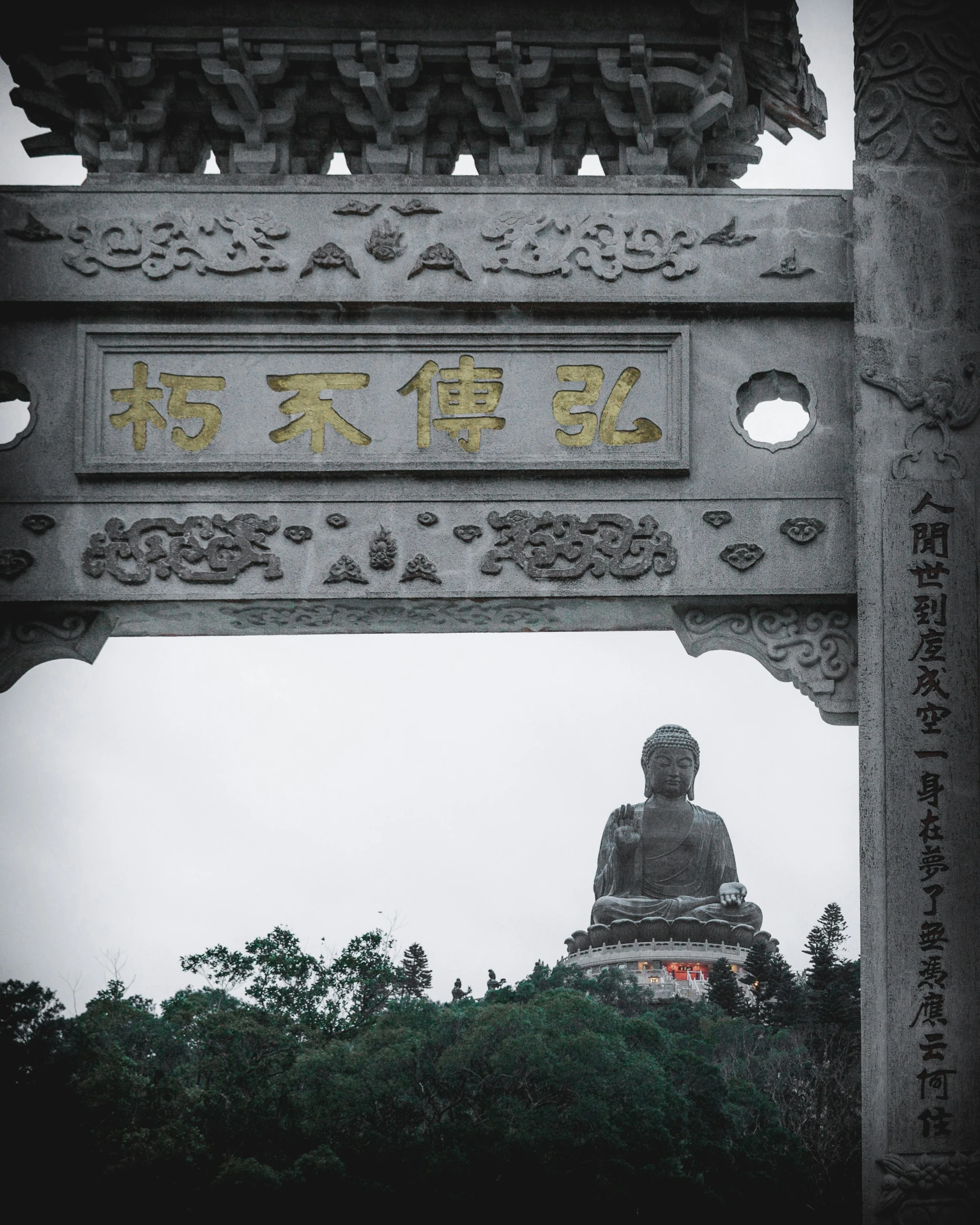 an iron gate with the statue of a person in the center