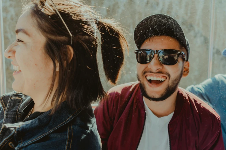 two people are laughing and talking in front of a building