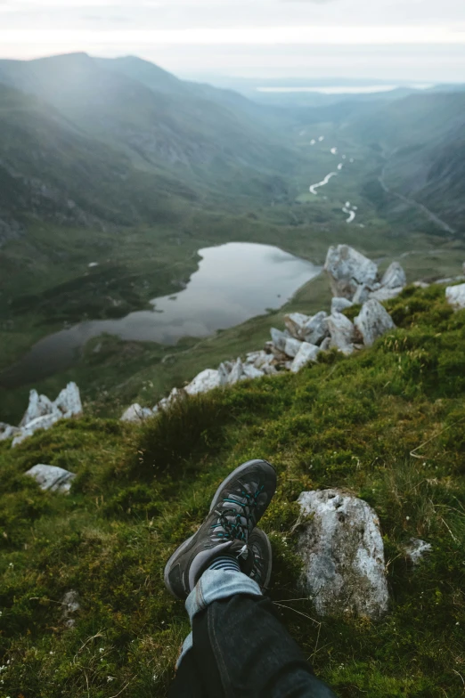 a pair of feet that are sitting on the grass