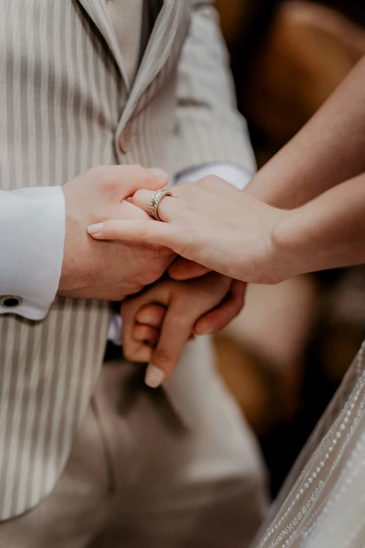 man and woman holding hands on their wedding day