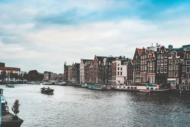 a city skyline with a river and buildings lining the sides