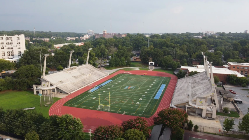 an aerial view of a field with sports fields and stadium