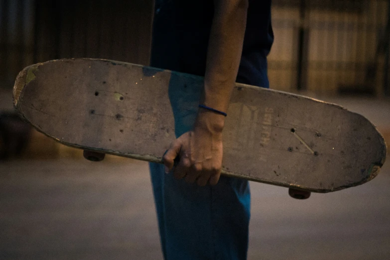 a man carrying a skate board across the street