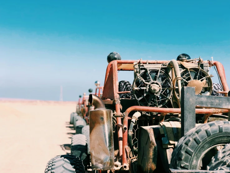 a close up of a group of cars parked in the desert