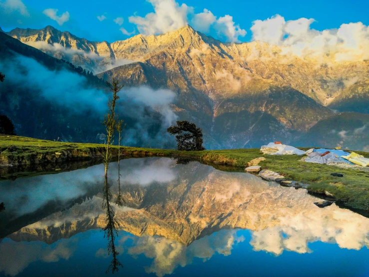 some mountains and a body of water are in the foreground