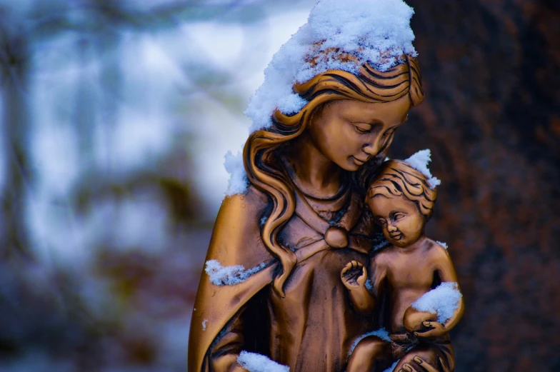 a statue of a mother and child holding a baby in her arms