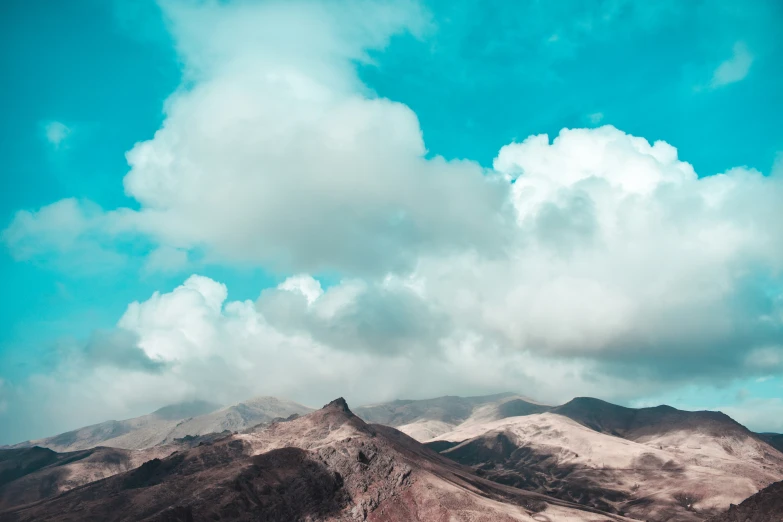 a view of a mountain range on a cloudy day