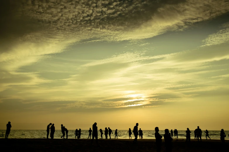 there are many people that are standing on the beach