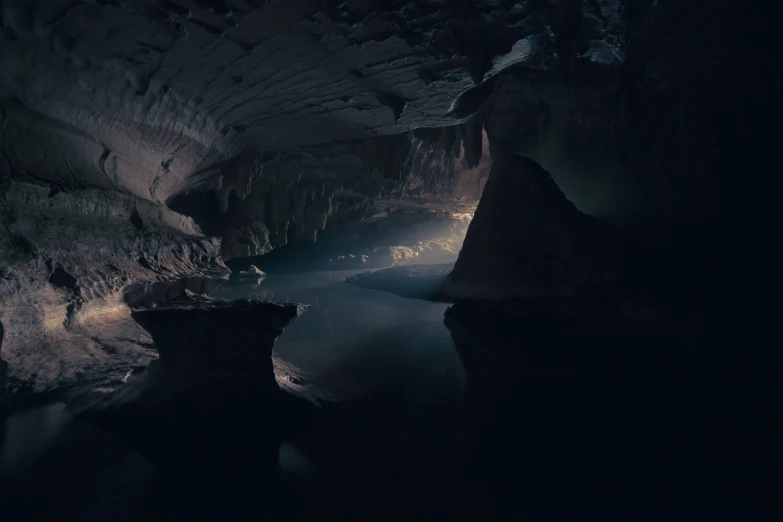 a view of water at night, in an underground cave