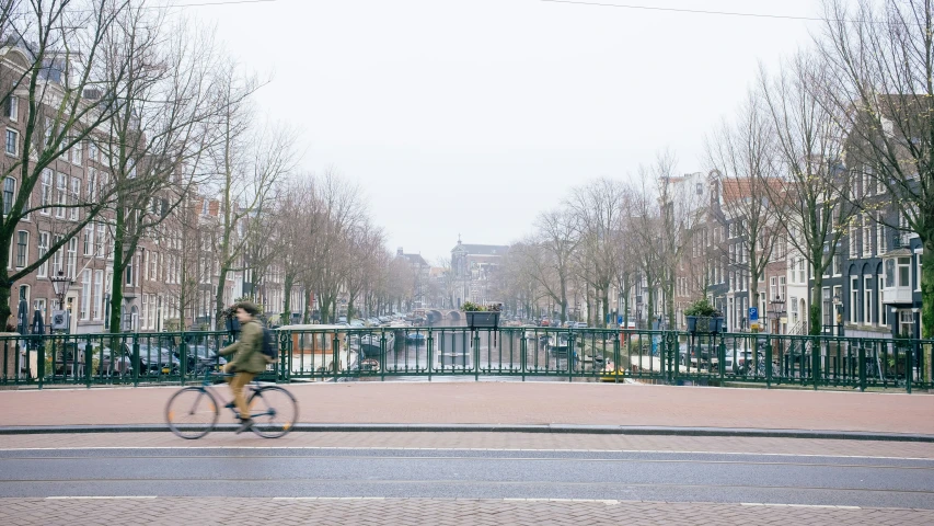 a person riding a bike on a city street