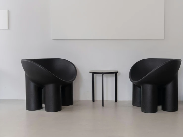 two very nice looking black chairs in a room