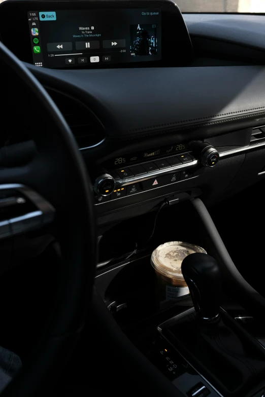 the car dashboard with touchscreen displays on and an air vent that is connected to the electronic controls
