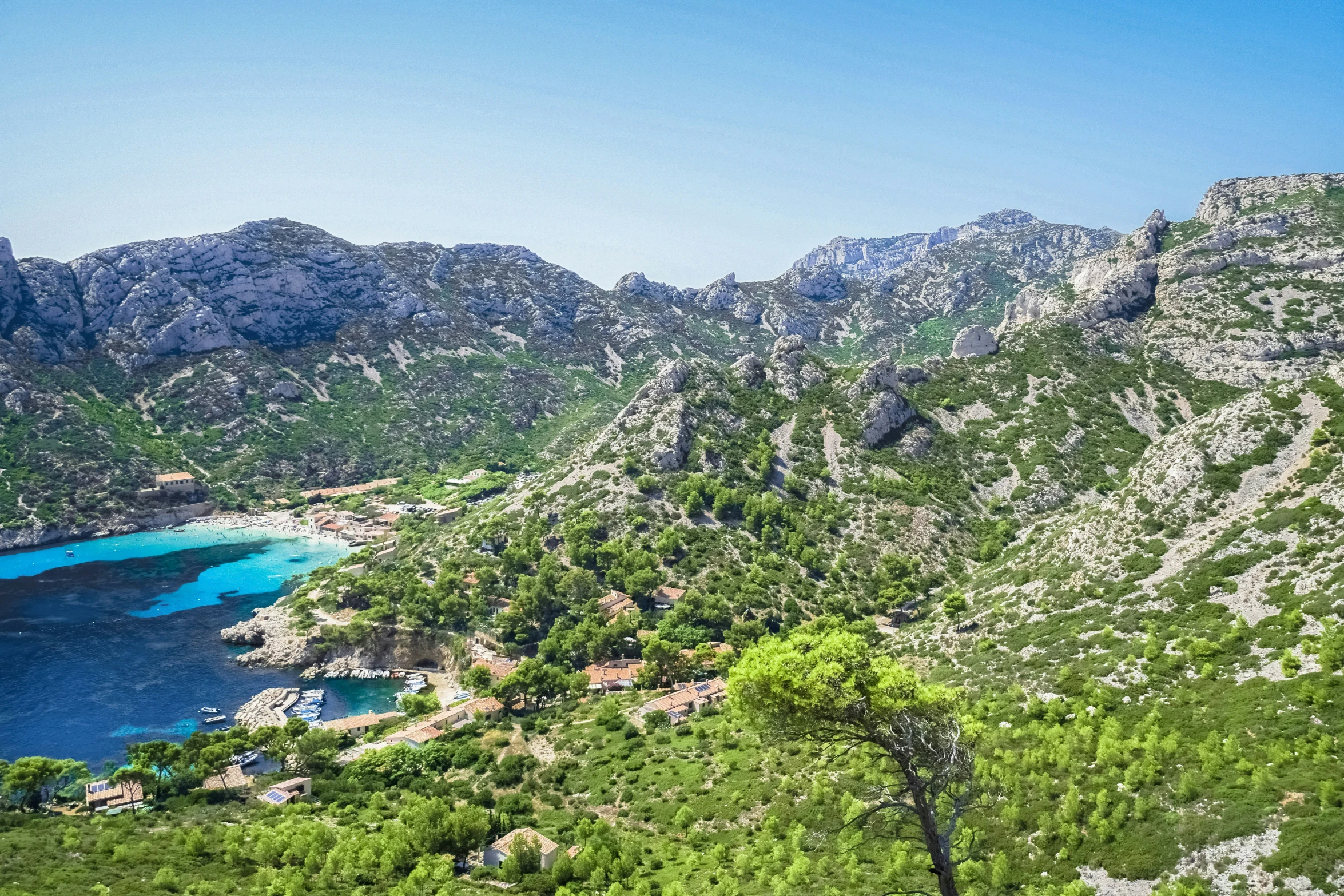 a mountain side area with a body of water