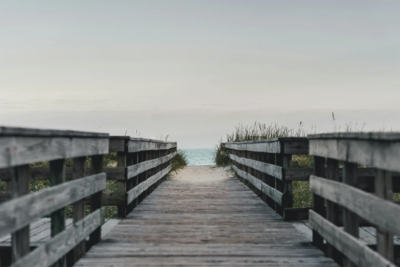 a dock going to the ocean in the distance