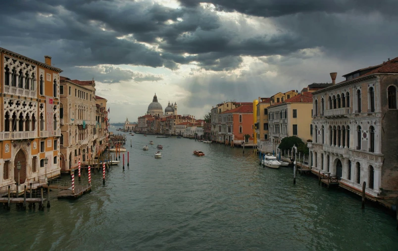 a canal in europe as dark clouds cover it