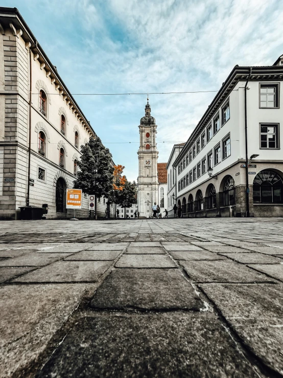 a clock tower towering over a city street