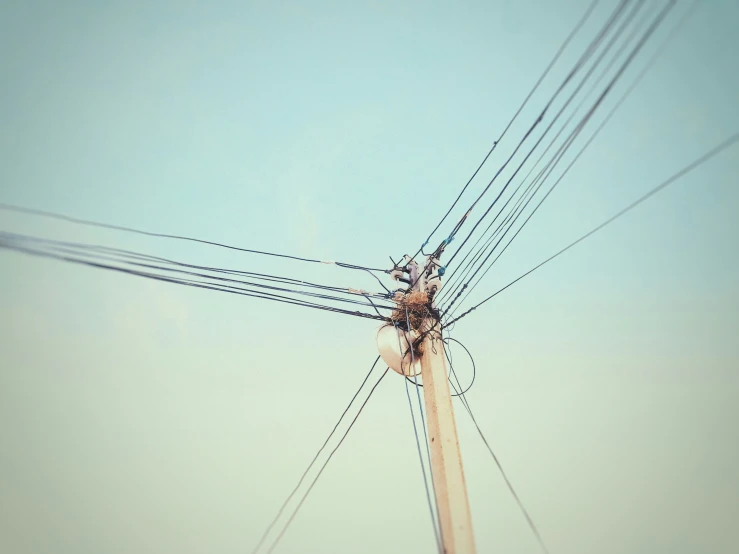 a high voltage electric pole is shown during the day