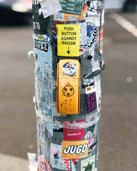 a street pole with various stickers on it