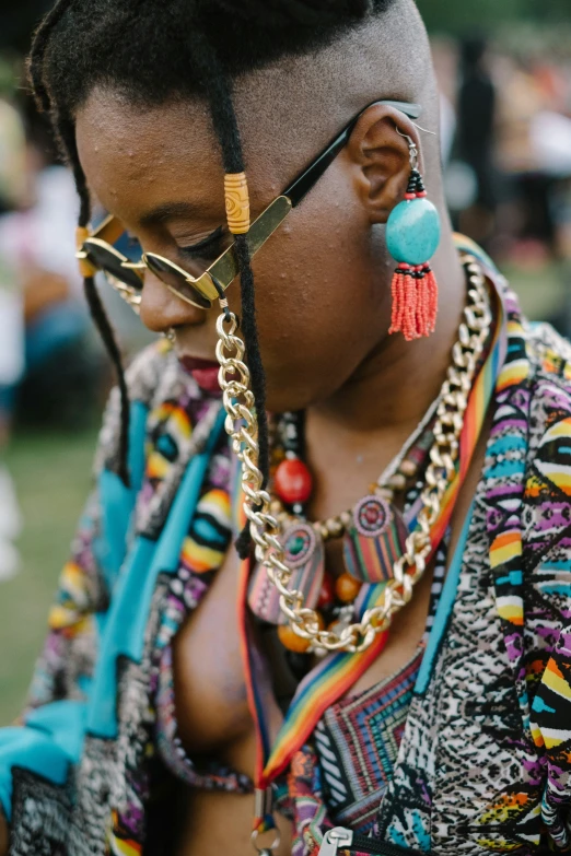 african american girl looking down while wearing colorful jewelry