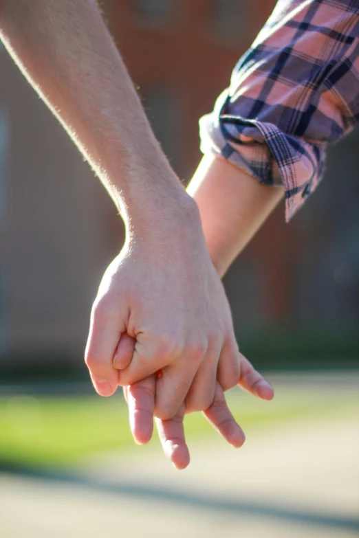 a couple holding hands as they reach out towards each other